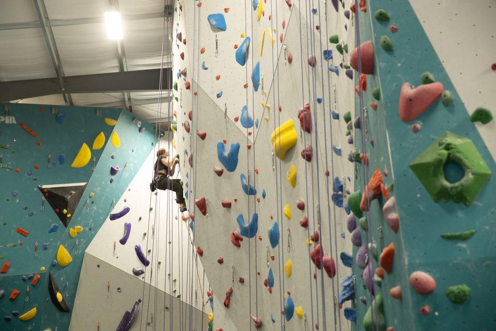 Send It Climbing Wall woman on rock wall